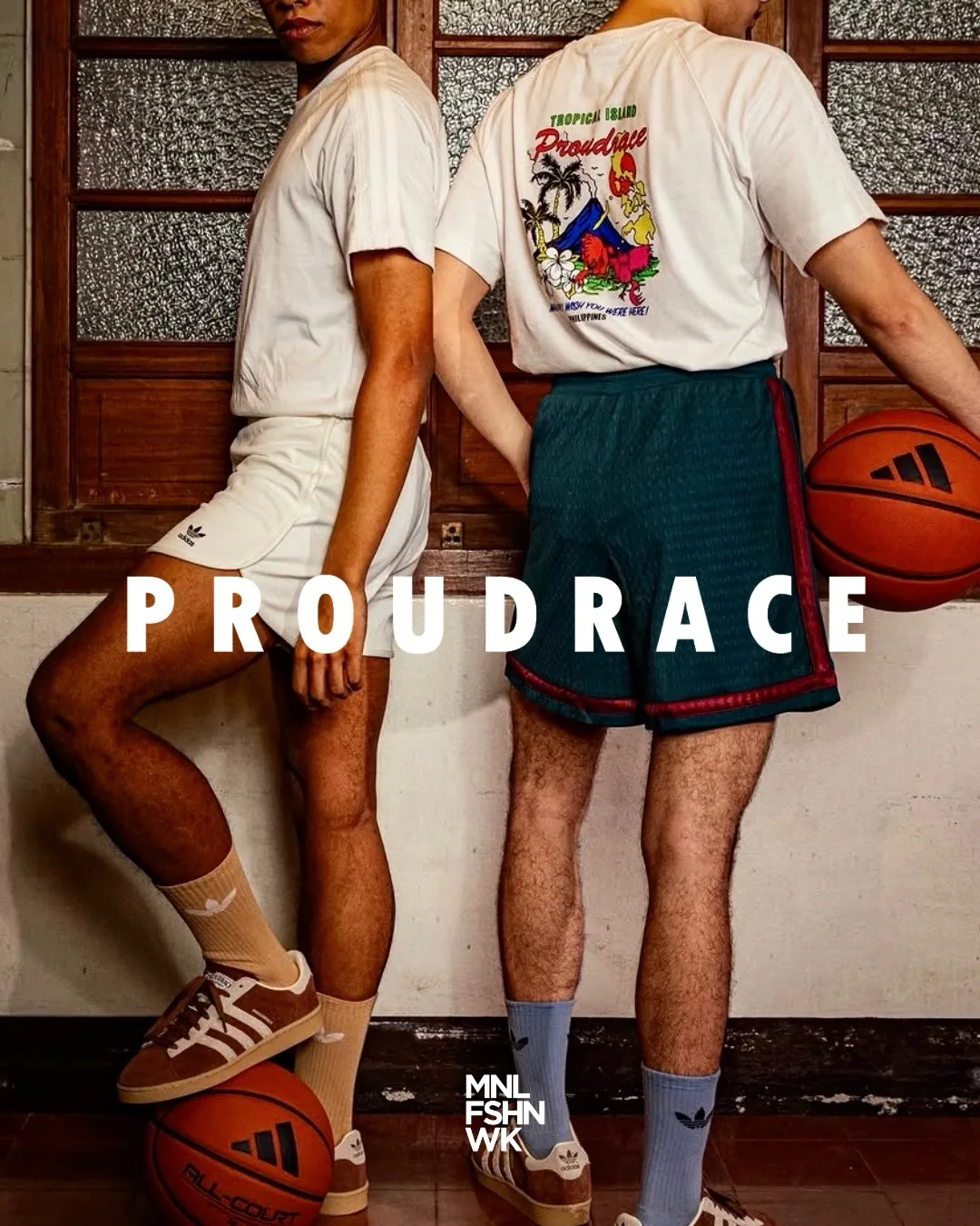 Two Proudrace models courtside in cream basketball fits, one in a Tropical Island graphic tee, holding basketballs in a Manila gymnasium