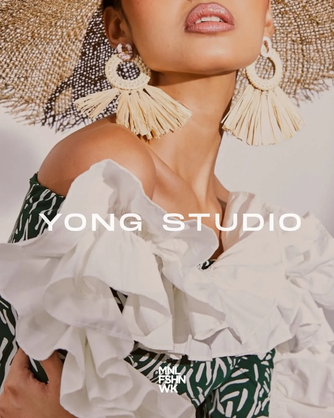 Yong Studio campaign portrait with woven raffia earrings, a ruffled white top, and a frayed straw hat